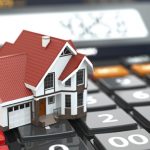 Real estate concept. House on calculator. Mortgage. 3d
