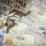 Small Model House and Keys on Newly Designed U.S. One Hundred Dollar Bills.