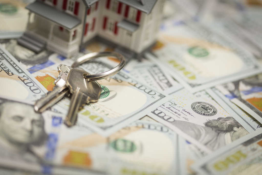 Small Model House and Keys on Newly Designed U.S. One Hundred Dollar Bills.