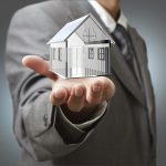 Business man present  diamond house model