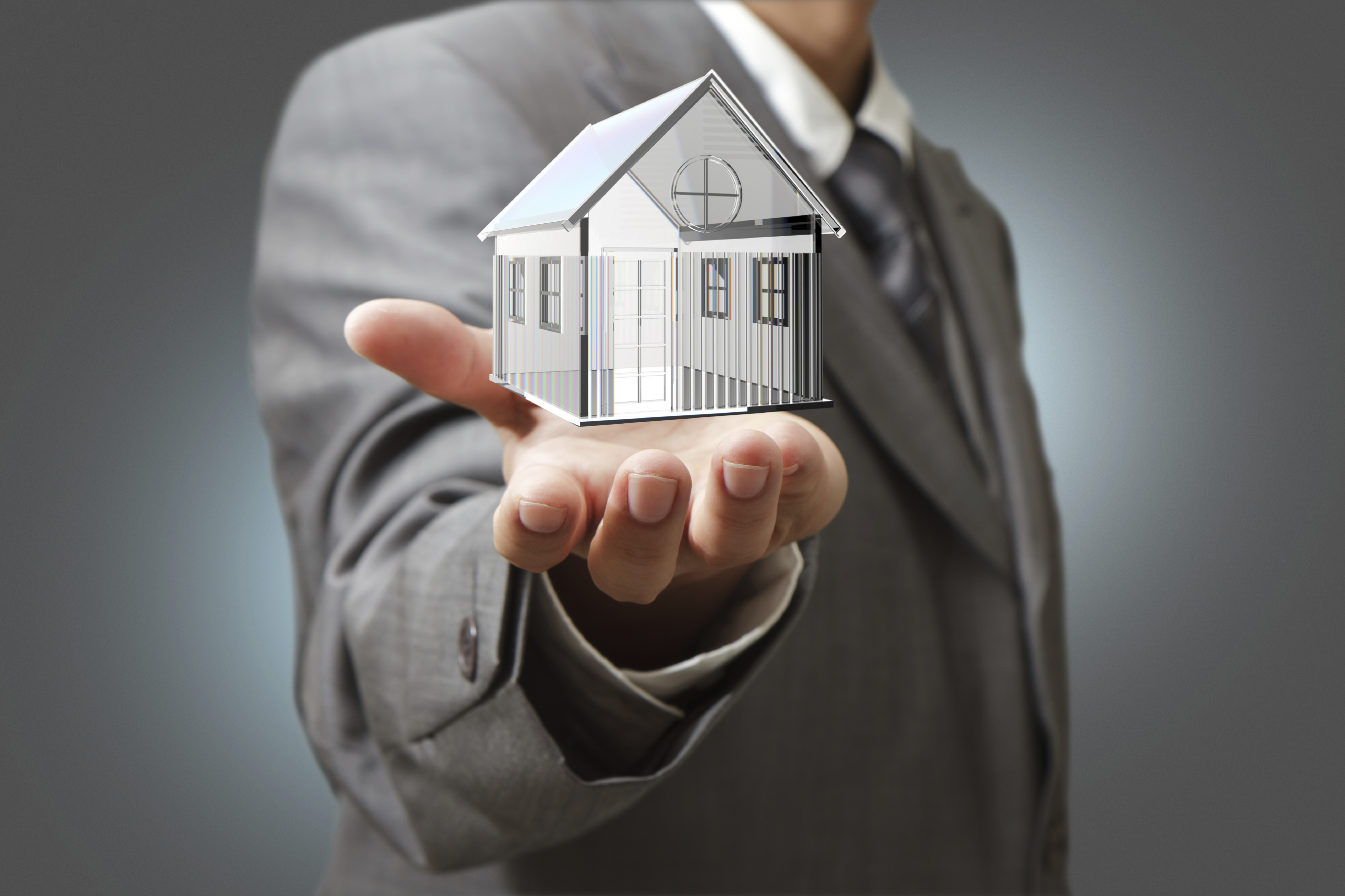 Business man present diamond house model