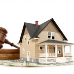 Home, money and gavel real estate concept; isolated on white with shallow depth of field